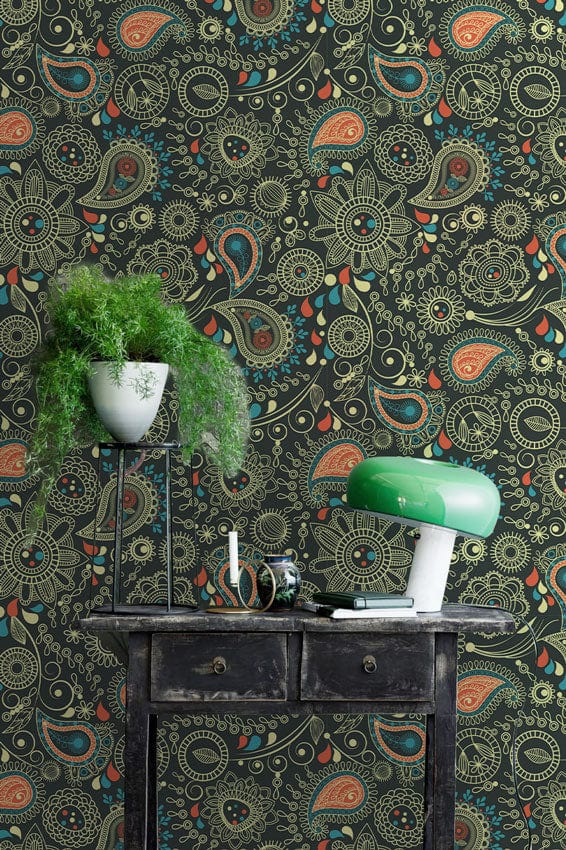 Elegant vintage green peach floral wallpaper in stylish room with dark table and modern green lamp.