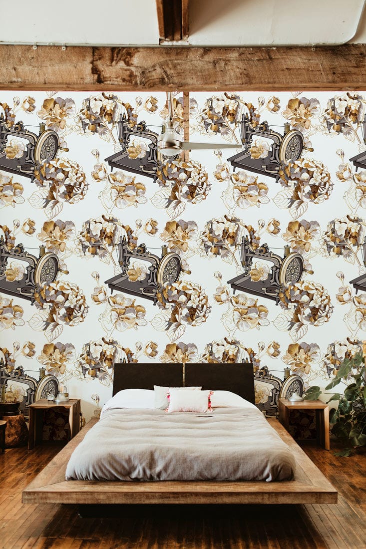Vintage sewing machine floral wallpaper, warm tones, bedroom setting, wooden flooring, rustic ceiling beams.