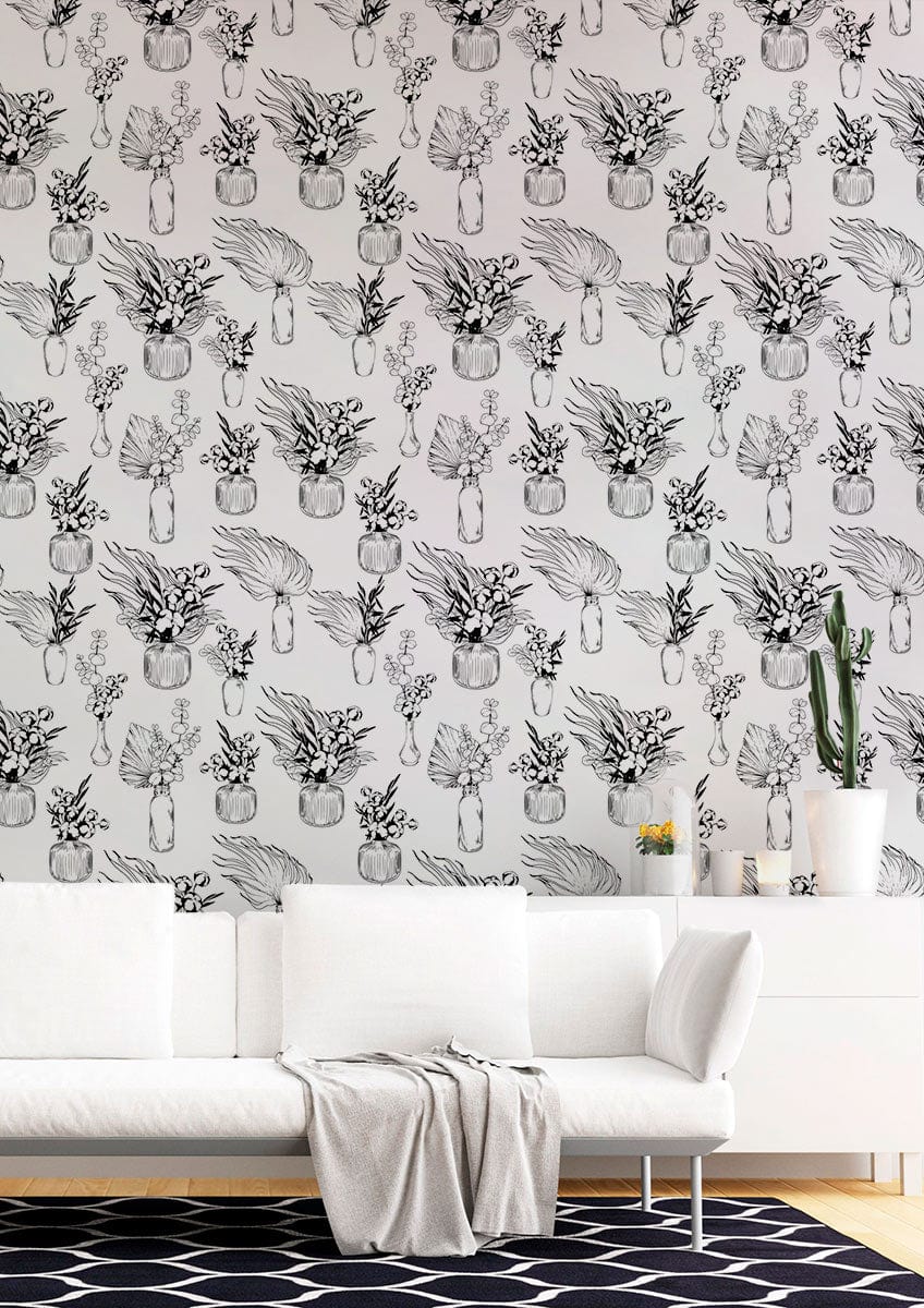 Monochrome botanical vase wallpaper in elegant room with white sofa, geometric rug, and minimal decor.