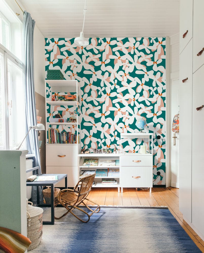 Elegant green and white birds wallpaper, modern room with wooden flooring, rug, cream furniture, desk.