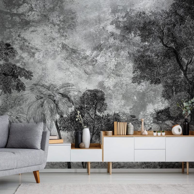 Monochrome tropical forest mural wallpaper with grey sofa, modern white console, neutral flooring, stylish decor.