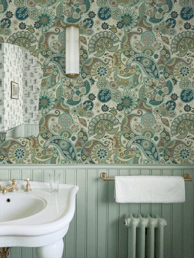 Vintage Paisley Elegance: Teal and Beige Wallpaper in Bathroom with Sink, Towel Rack, Mirror, Light Fixture.