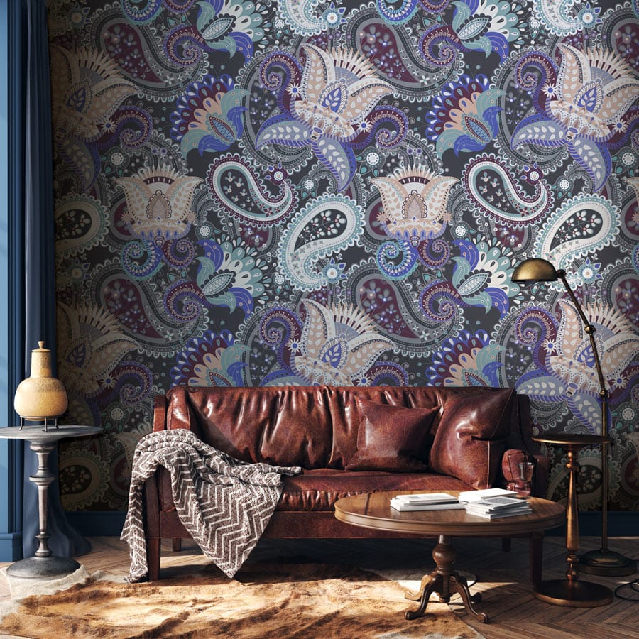Paisley Passion floral wallpaper with leather sofa, vintage table, and floor lamp in cosy living room.