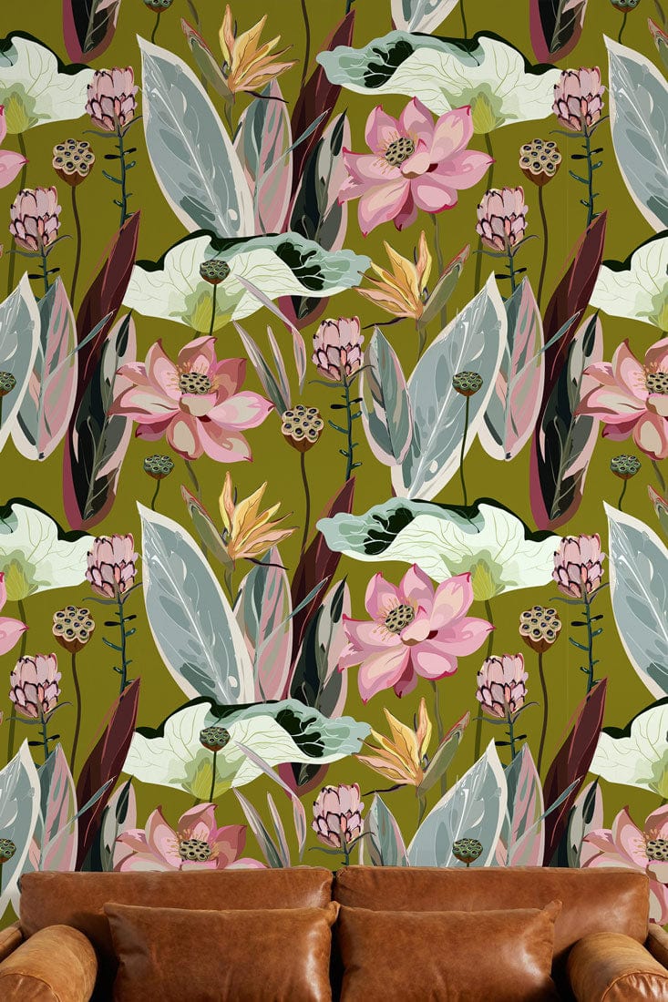 Elegant Botanical Oasis wallpaper with green-pink floral pattern, brown leather sofa, in stylish living room.