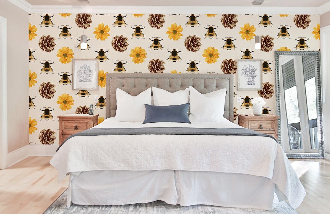Vintage-inspired bee and floral wallpaper, rustic yellow/brown, in bedroom with grey upholstered bed.