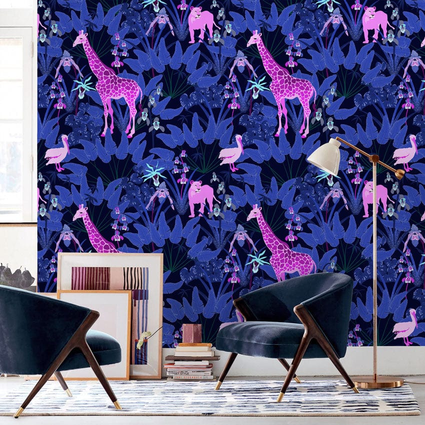 Vibrant Jungle Nights wallpaper with purple safari design, blue velvet chairs, modern room setting.