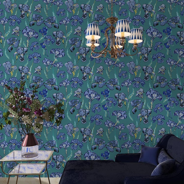 Blue botanical garden floral wallpaper in elegant living room with navy sofa and gold chandelier.