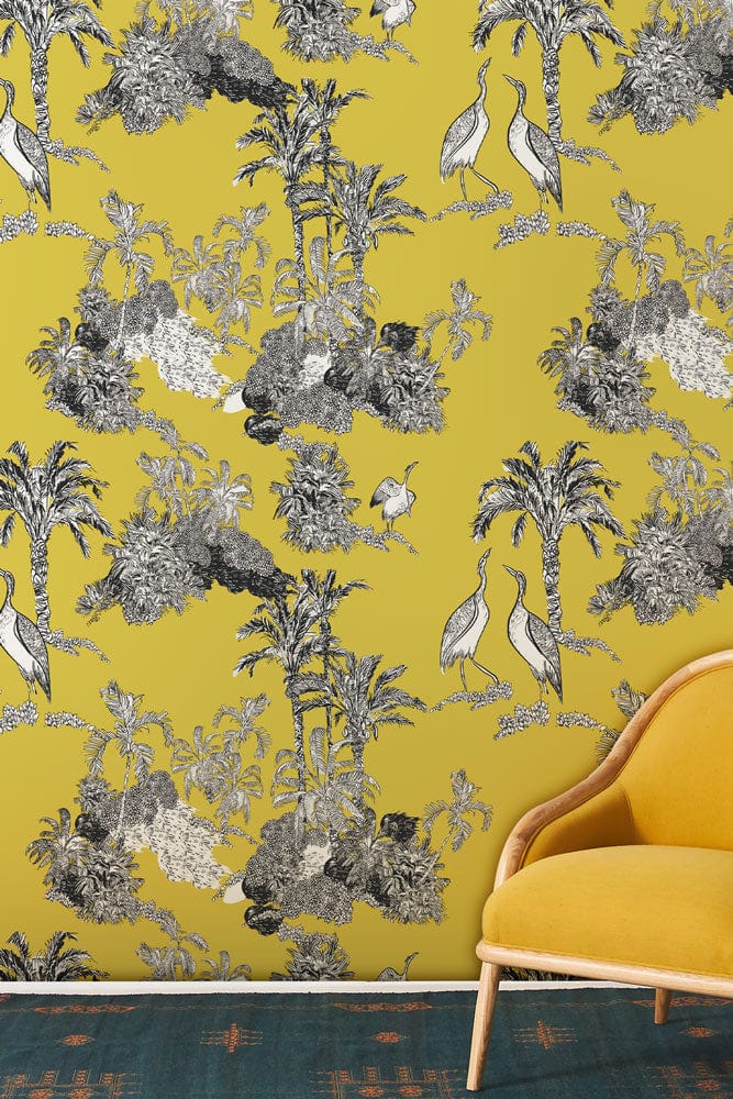 Golden Tropical Oasis Toile wallpaper, yellow-grey elegance; mustard sofa, teal carpet; stylish living room.