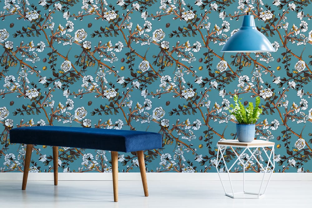 Elegant teal wallpaper with floral pattern and white roses, blue bench, stylish lamp in modern room.