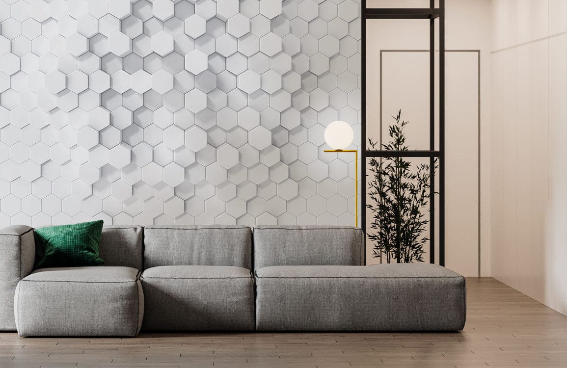 Geometric white hexagonal 3D wallpaper with grey sofa, green cushion, wooden floor, modern minimalist style.