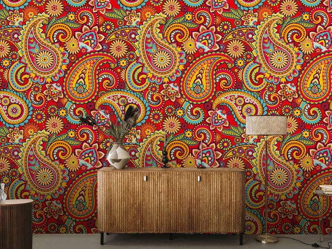 Vibrant Paisley Floral Red Wallpaper in bohemian style decor with wooden cabinet and floor lamp.