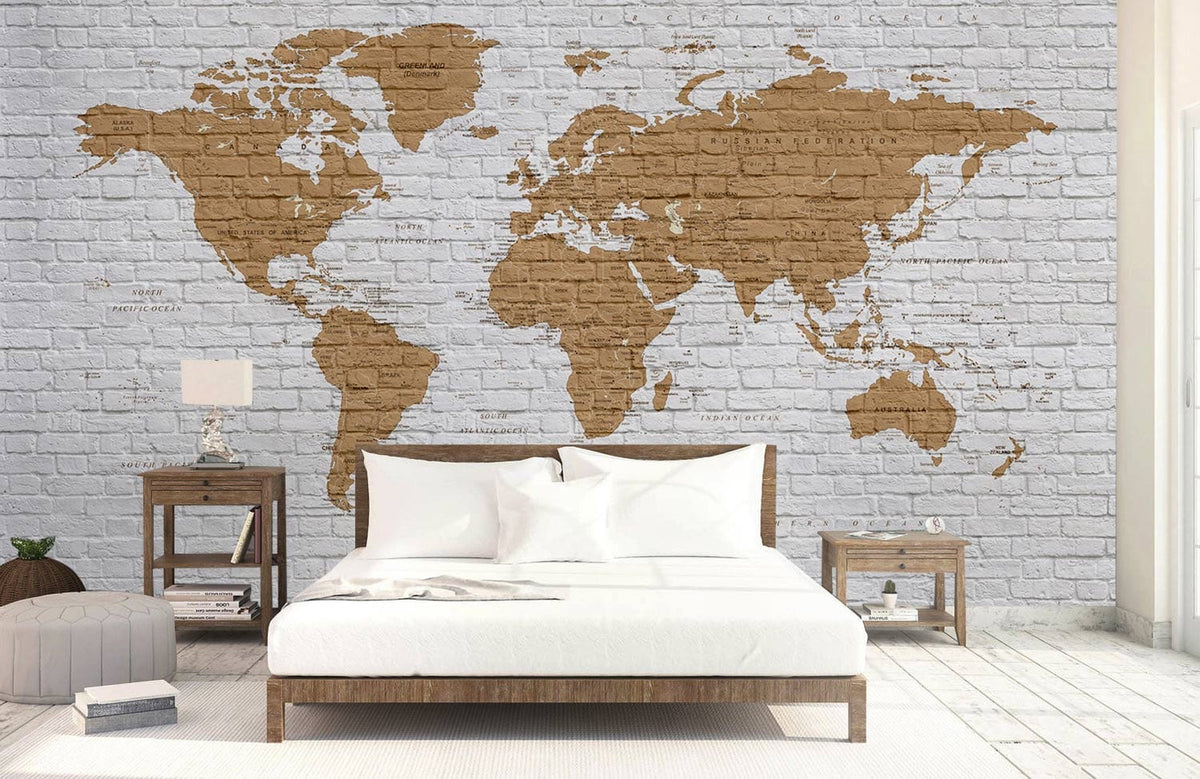 Vintage Brick World Map Mural Wallpaper adorns rustic bedroom with white bed, wooden furniture, and flooring.