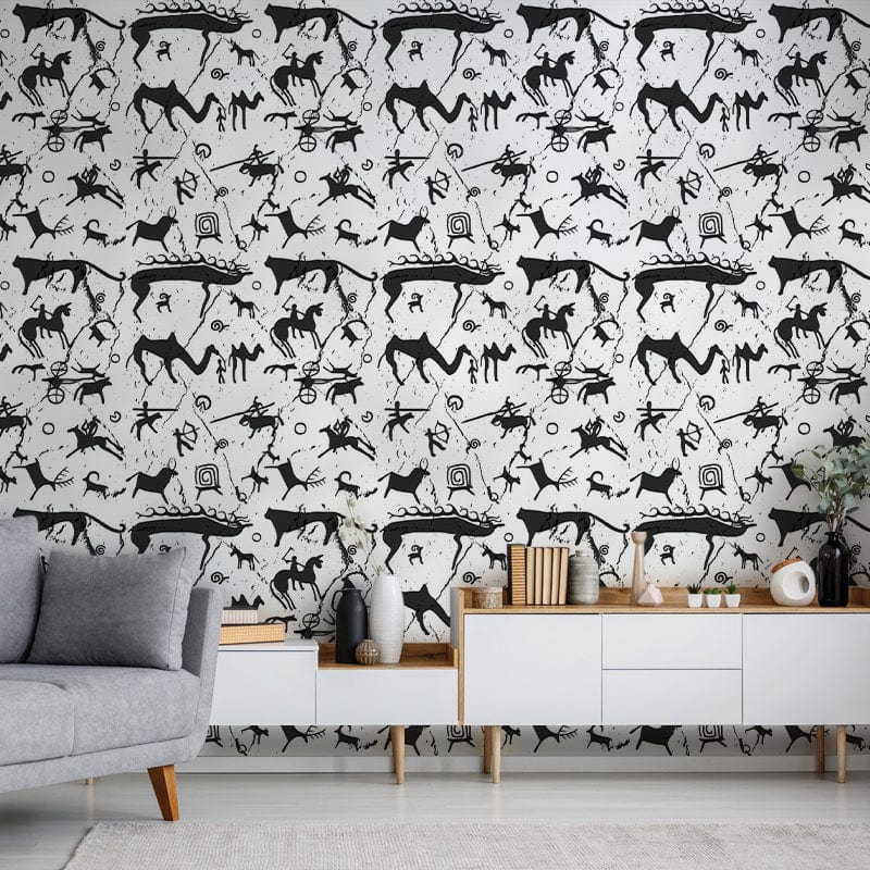 Monochrome petroglyph pattern wallpaper with grey sofa, wooden sideboard, and white drawers in living room.