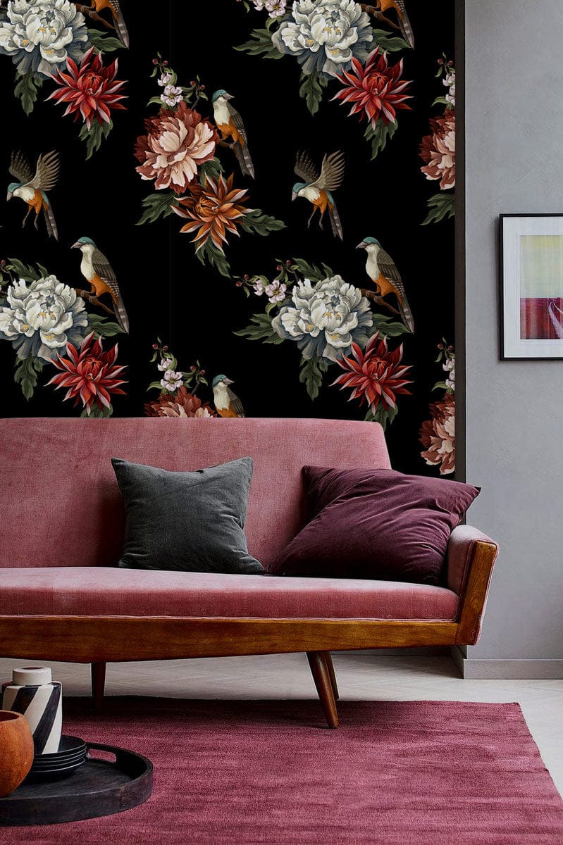 Elegant floral bird pattern wallpaper with cosy pink sofa in contemporary living room setting.