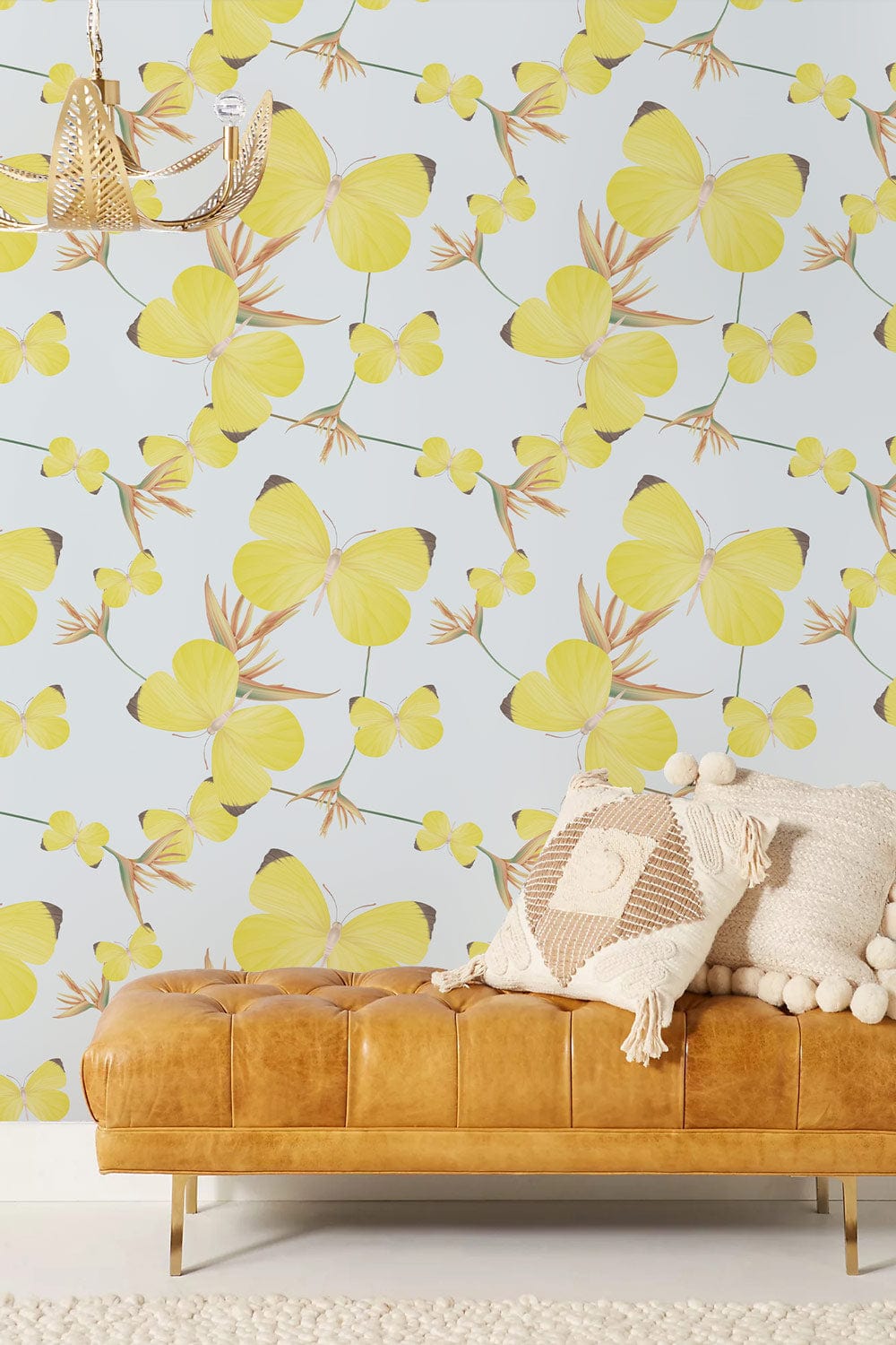 Sunny Yellow Butterfly Bliss Wallpaper Mural, tan leather sofa, beige rug, chandelier in modern room.