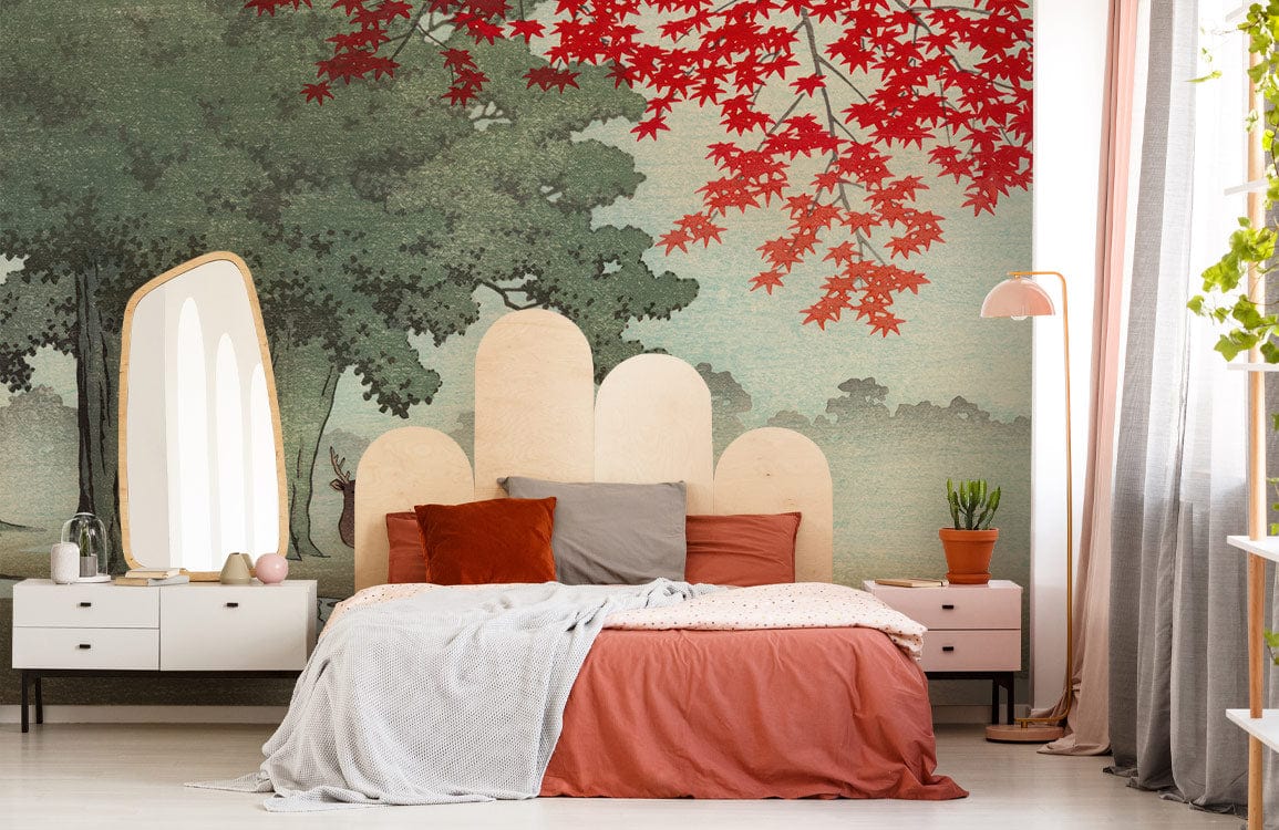 Bedroom with Misty Forest Deer Mural, red autumn leaves, neutral bed, white dresser, and grey curtains.