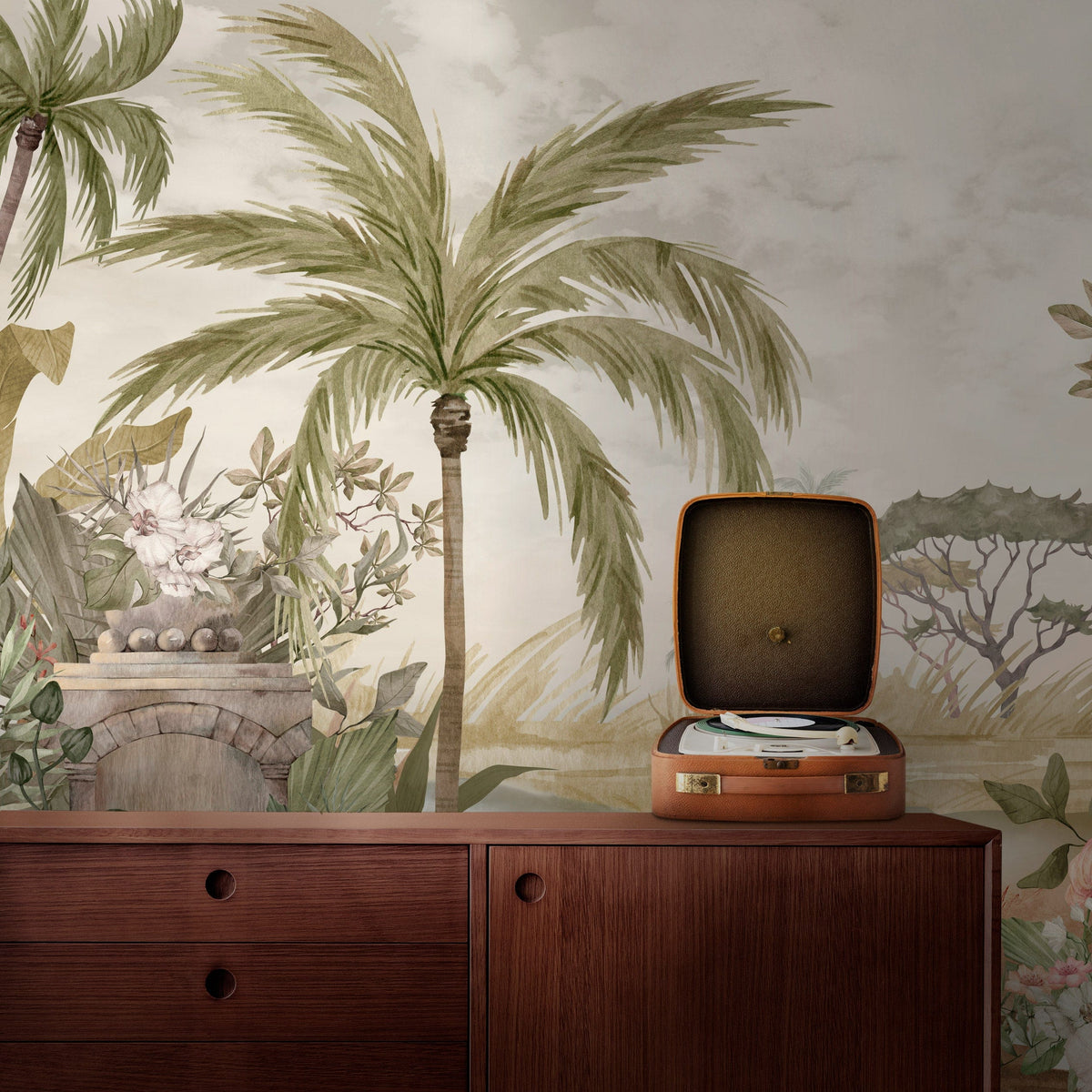 Tropical Watercolour Mural Wallpaper in soft greens; mid-century wooden sideboard; vintage record player displayed.