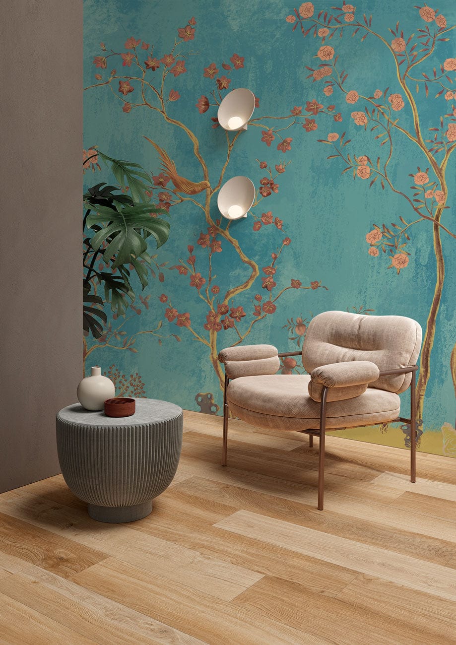 Elegant turquoise floral wallpaper with birds, pink blossoms, beige armchair, wooden flooring, and modern decor.