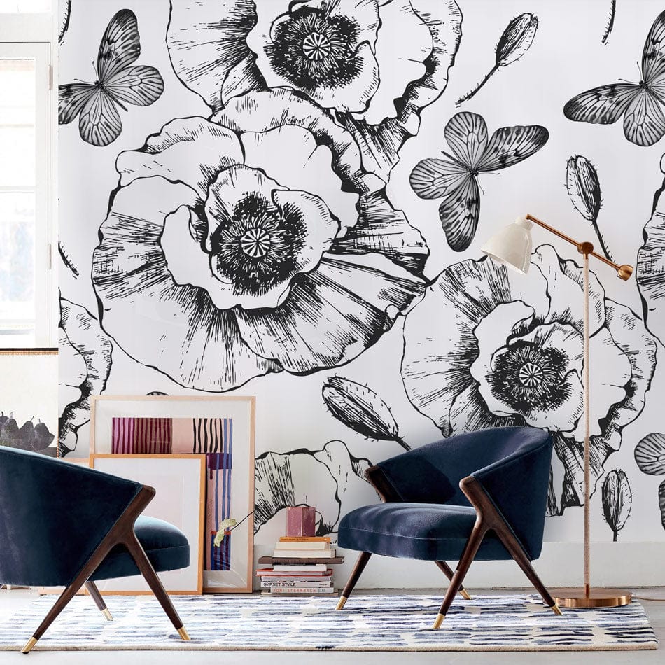 Monochrome floral butterfly wallpaper, black armchairs, modern rug accents, elegant living room decor.