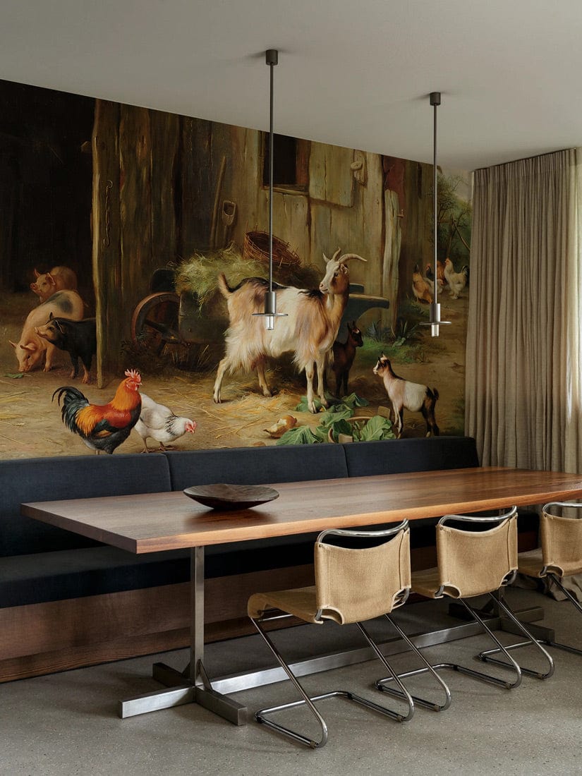 Rustic farmyard animal mural in dining room with modern table, beige chairs, and pendant lights.