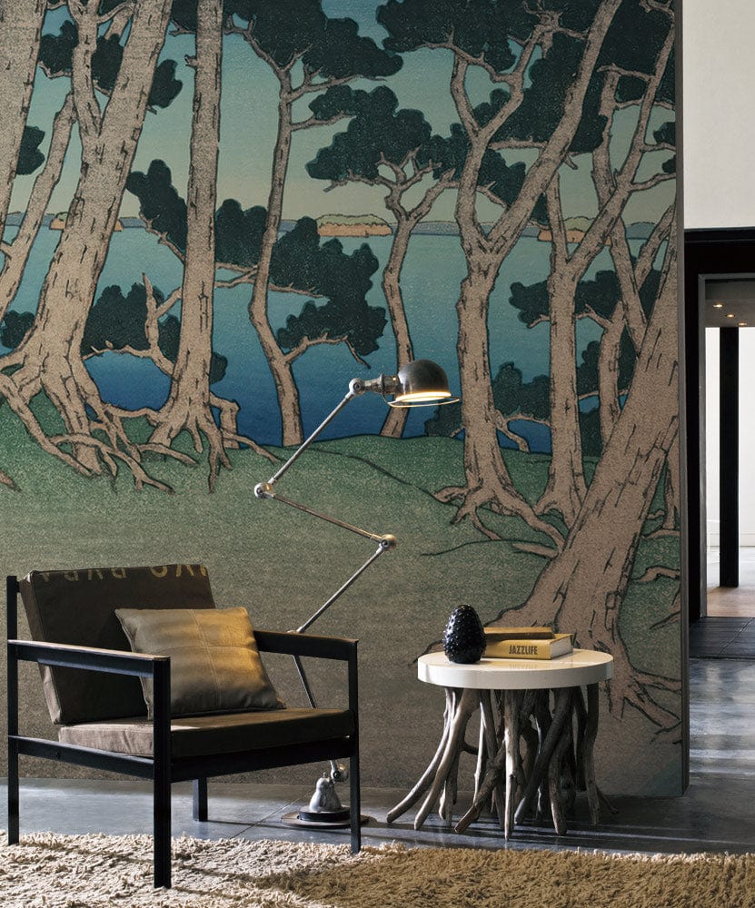 Tranquil forest mural wallpaper in contemporary room with modern chair, rustic table, and unique lamp.