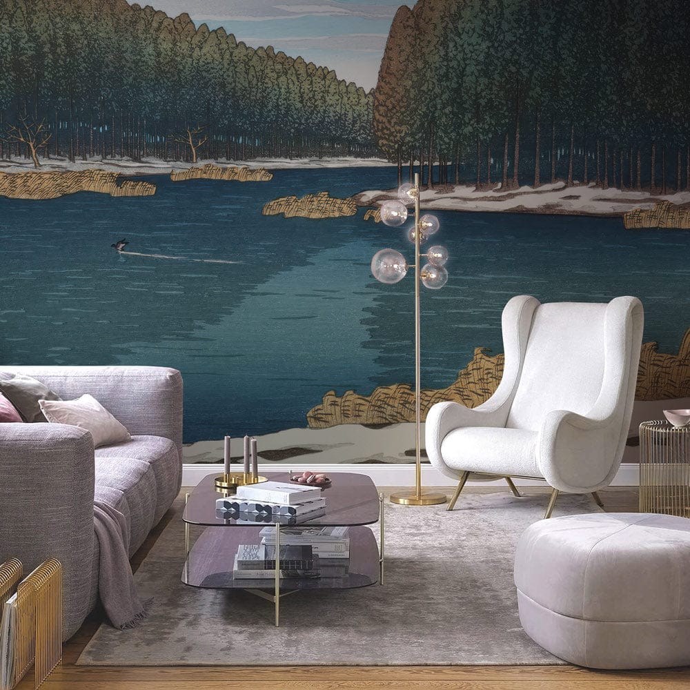 Lake and Pine Scenic Wallpaper in living room with grey sofa, modern chair, glass table, and rug.