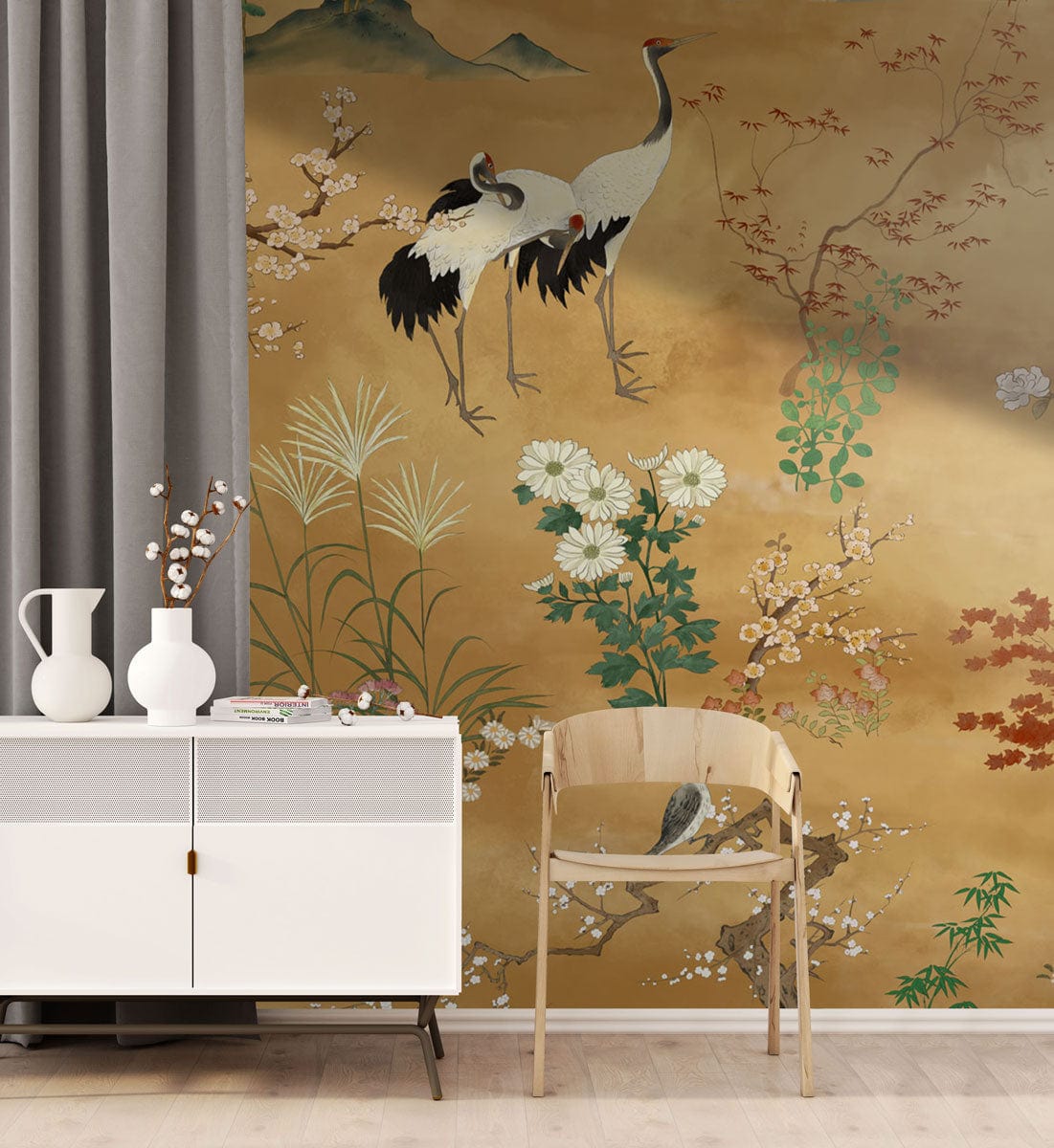 Vintage crane and floral mural wallpaper with white sideboard, beige chair, grey curtains, wood flooring.