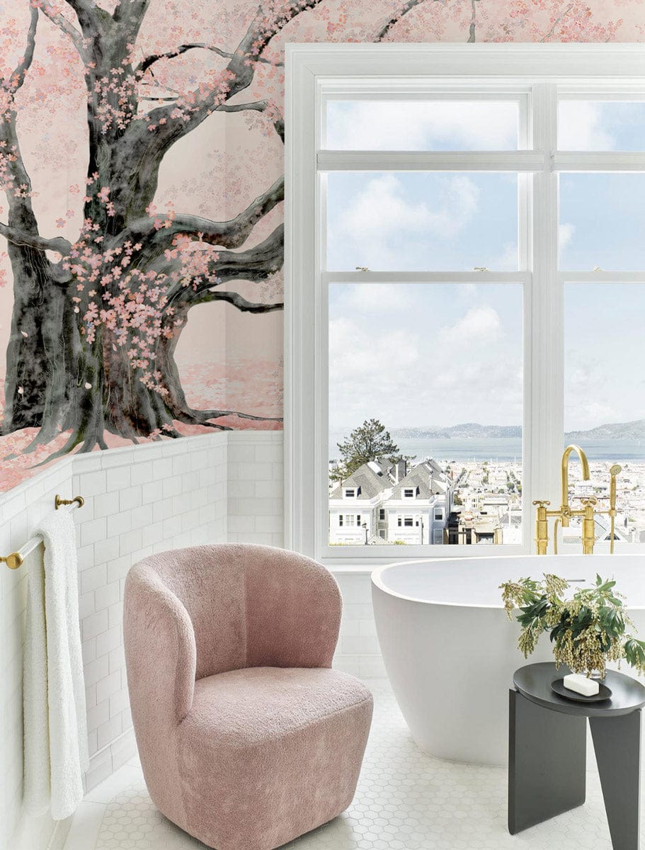 Elegant Cherry Blossom Mural Wallpaper, soft pink chair, white hexagonal flooring, luxurious bathroom setting.