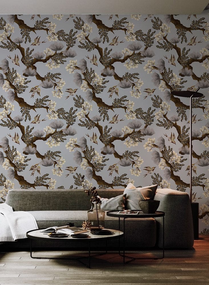 Vintage Botanical Elegance grey floral wallpaper in modern living room with grey sofa and wooden flooring.