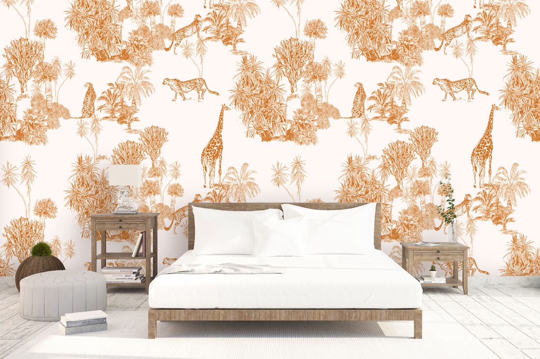 Vintage Safari Oasis wallpaper featuring orange giraffes and cheetahs in white bedroom with wooden bed.