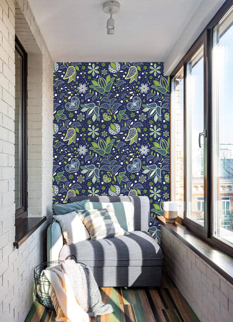 Midnight blue floral wallpaper in cosy sunlit room, with grey sofa and striped wooden flooring.