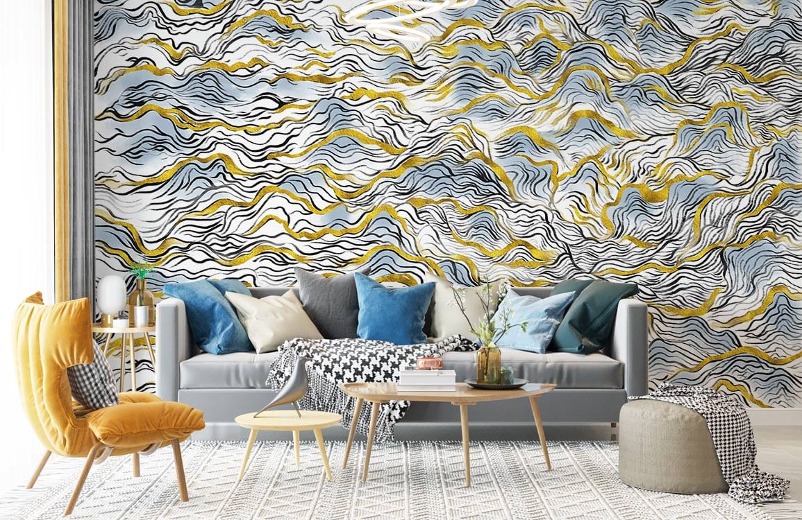 Elegant abstract waves wallpaper mural in blue and gold, grey sofa, yellow chair, geometric rug.