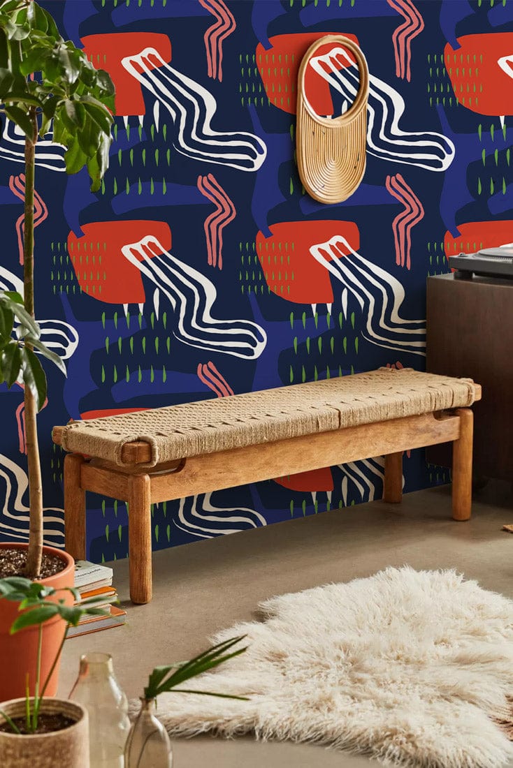 Contemporary abstract navy and coral wallpaper with geometric pattern, wooden bench, shaggy rug on concrete.