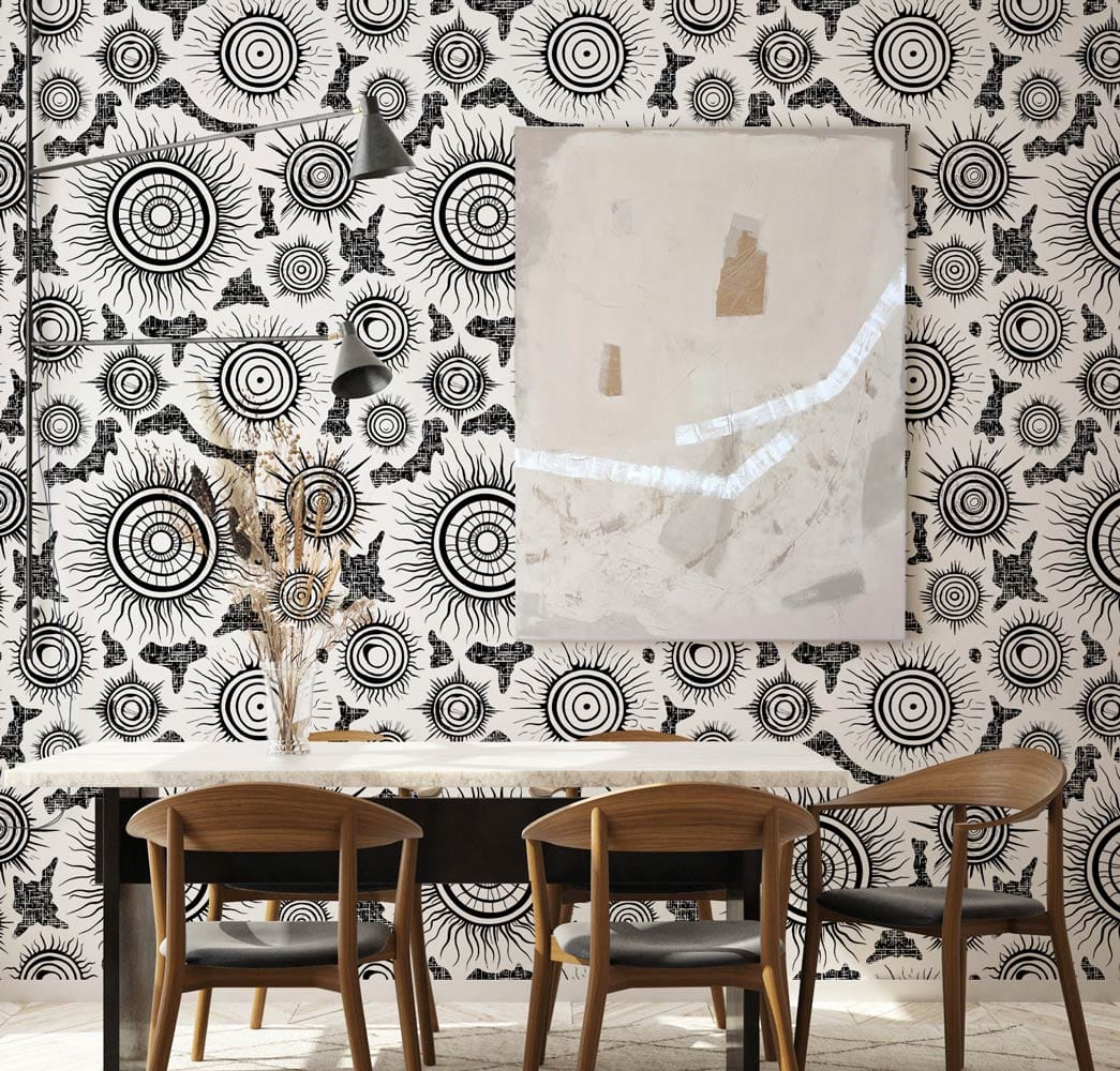 Monochrome Sunburst Mandala wallpaper in dining room with wooden chairs, elegant table, abstract art.