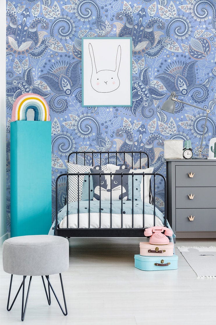Elegant blue floral paisley wallpaper in children's room, grey dresser, black bed, and soft flooring.