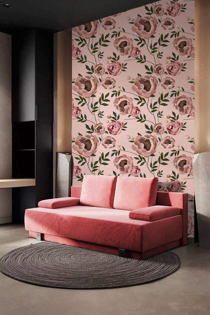 Pink floral wallpaper with green accents, red sofa, grey round rug, modern living room aesthetic.