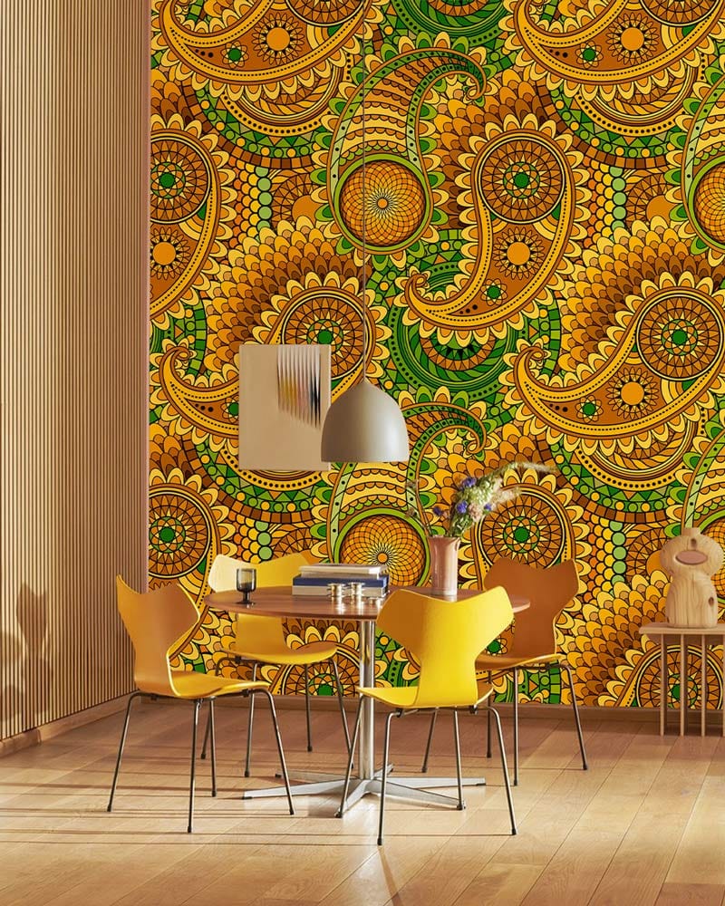 Vibrant green-yellow paisley wallpaper in dining room with wooden floor, yellow chairs, modern lighting fixture.