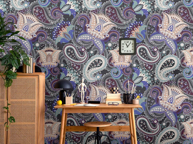 Paisley Passion wallpaper in blue and cream, paired with wooden desk, chair, and cane cabinet.