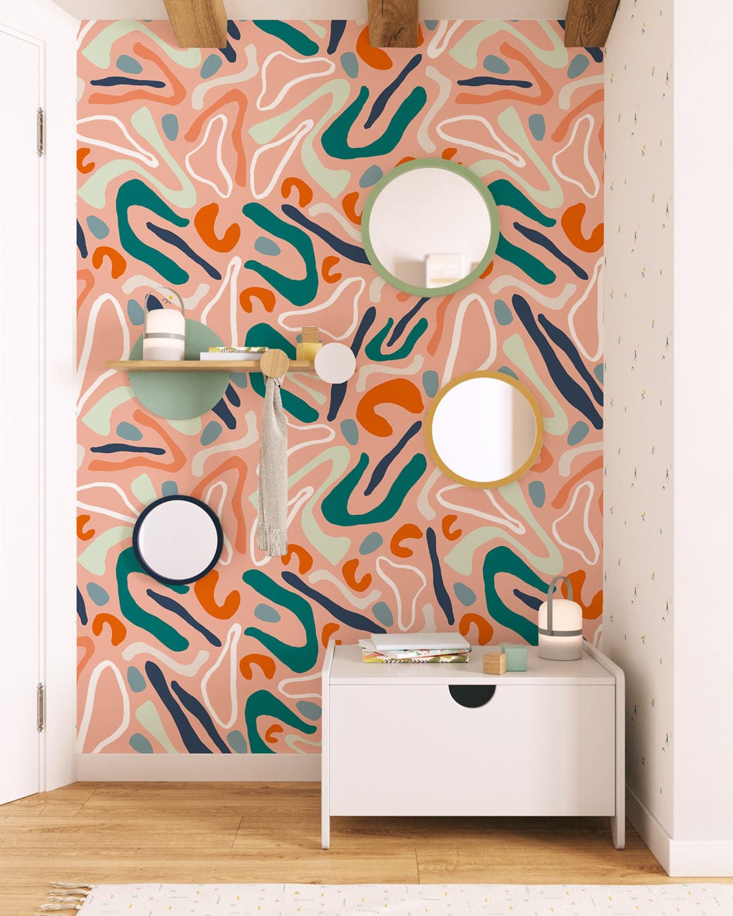 Abstract terracotta and teal wallpaper in modern room with mirrors, wood flooring, white storage bench.