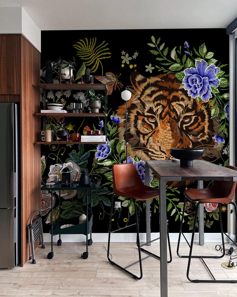 Floral Tiger Jungle Mural Wallpaper, vibrant kitchen decor, wood cabinets, modern high stools, light flooring.