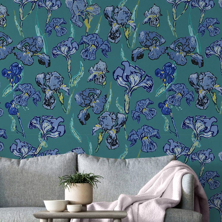 Blue Botanical Garden Floral Wallpaper in living room with grey sofa and cosy beige throw blanket.