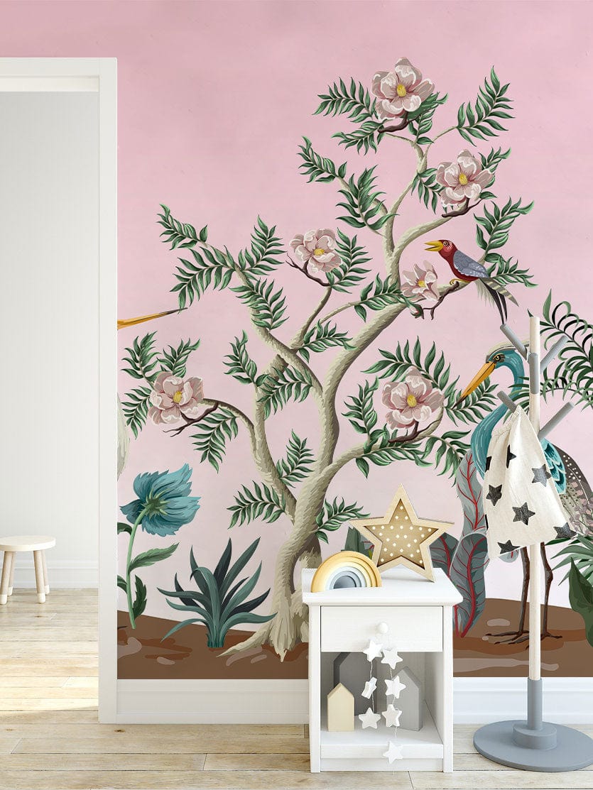Elegant pastel botanical bird mural wallpaper in a child's room, pink wall, wooden flooring, white furniture.