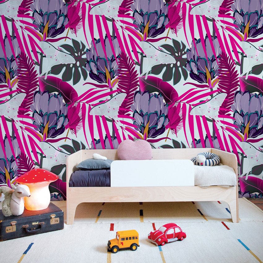 Tropical Jungle Mural Wallpaper behind wooden bed in children's room, featuring playful decor and colourful rug.