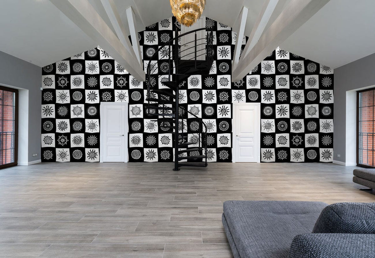 Monochrome geometric patterned wallpaper, black spiral staircase, grey sofa, wood flooring, spacious living room.