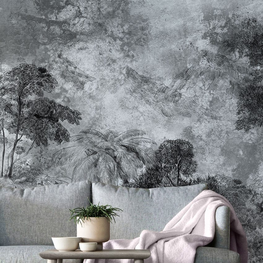 Monochrome tropical forest mural with grey sofa, light wood flooring in living room. Elegant wall decor.