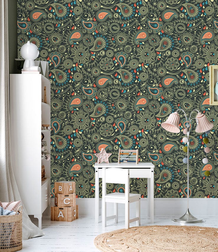 Elegant green and peach paisley wallpaper; white desk, floor lamp, woven rug, children's room setting.