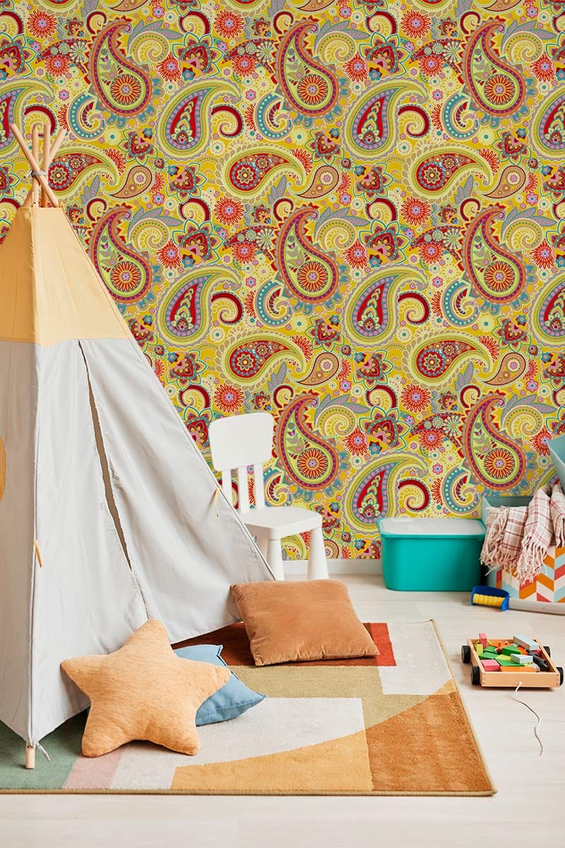 Vibrant multicoloured paisley wallpaper in playful room with play tent, cushions, and colourful storage.