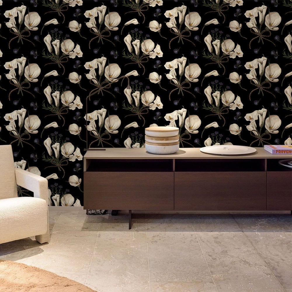 Elegant vintage floral black wallpaper with lily pattern; beige chair; wooden sideboard; tiled flooring.