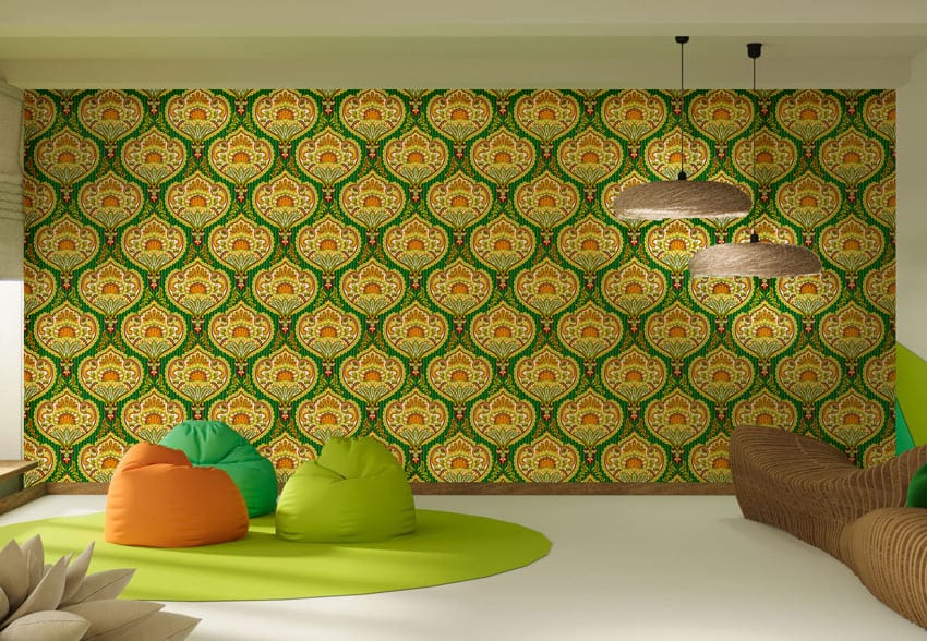 Luxurious green and gold vintage wallpaper in living room with bean bags, wicker sofa, pendant lights.