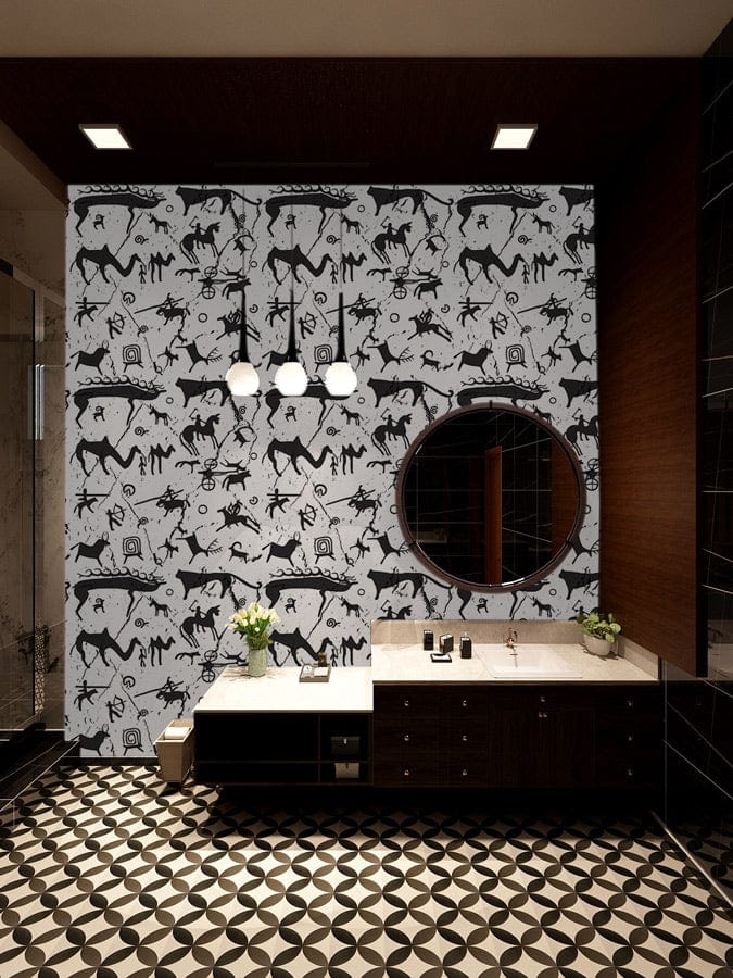 Monochrome prehistoric petroglyph wallpaper in modern bathroom with geometric tile flooring, round mirror, vanity.